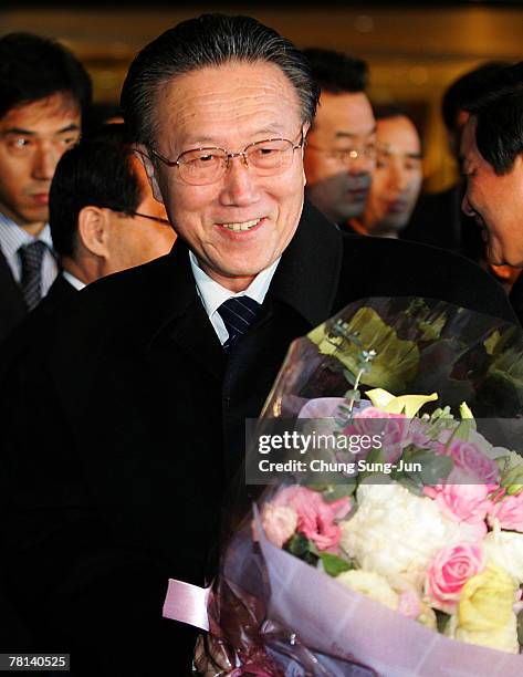 North Korea's United Front Department of Workers' Party Director Kim Yang-Gon is given flowers upon his arrival at a Walkerhill Hotel on November 29,...