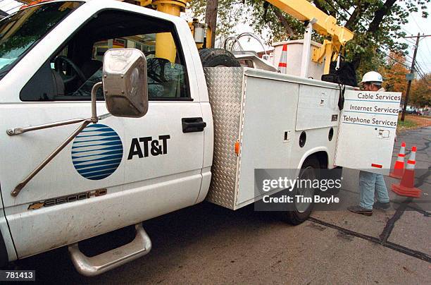 An AT&T advance-line technician parks his service truck October 26, 2000 as he prepares to troubleshoot an aerial cable in Des Plaines, Illinois. On...