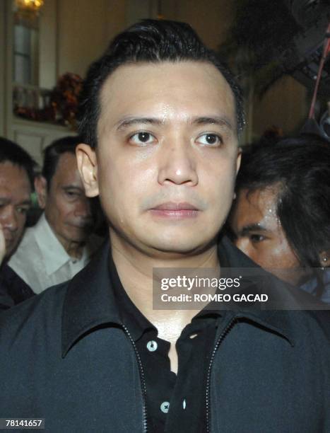 Philippine Senator Antonio Trillanes, leader of the rebel soldiers who have taken over the luxury Peninsula hotel, faces journalists inside the hotel...