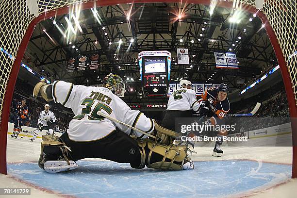 Marty Turco of the Dallas Stars protects the goal during the NHL game against the New York Islanders at Nassau Coliseum on November 26, 2007 in...