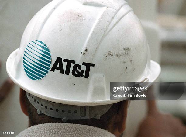 The AT&T logo is seen on the safety helmet of advance-line technician Fred Murray October 26, 2000 in Des Plaines, Illinois. On October 25 AT&T Corp....