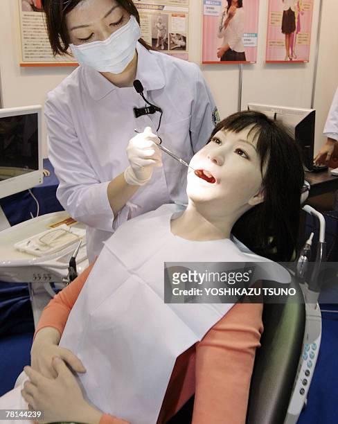 Japan's Nippon Dental University Hospital staff Yuko Uchida demonstrates a humanoid robot of dental therapy simulator "Simroid" for dentists and...