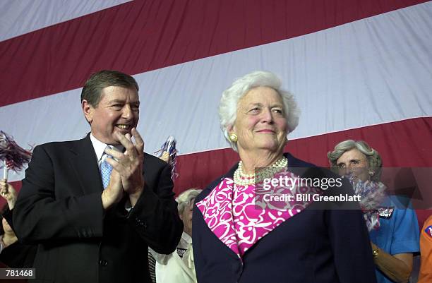 Fomer first lady Barbara Bush receives applause from U.S. Senator John Ashcroft, R-MO, after speaking at a republican rally October 26 , 2000 at...