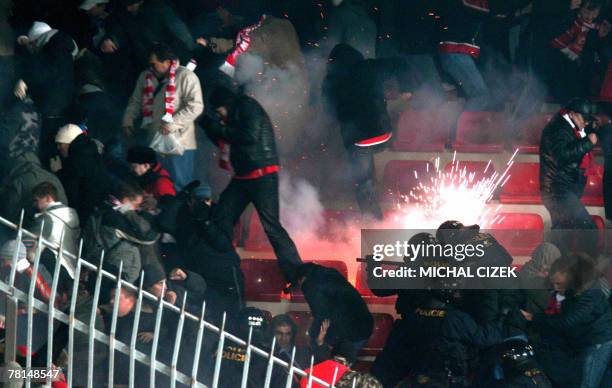 Helmeted anti-riot policemen clash with Spartak Moscow's fans during an UEFA Cup Group E soccer match Sparta Prague vs Spartak Moscow in Axa Arena,...