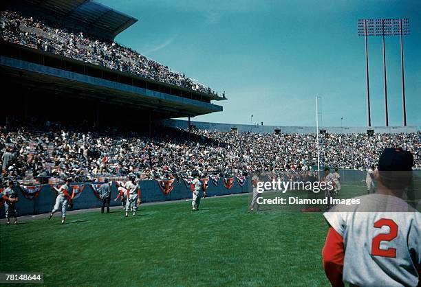 Members of the St. Louis Cardinals warm up prior to the start of the Opening Day game on April 12, 1960 against the San Francisco Giants at...