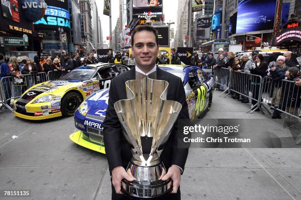 Jimmie Johnson, the 2007 NASCAR Nextel Cup Champion, poses with the NASCAR Nextel Cup Trophy in Times Square during NASCAR Champions Week November...