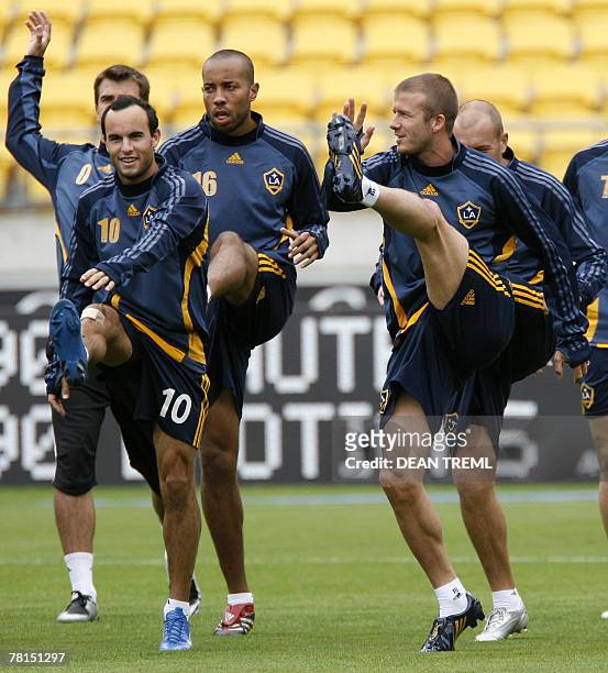 David Beckham of the LA Galaxy stretches with team mates in font of a crowd of thousands who attended the team's open training session in at Westpac...
