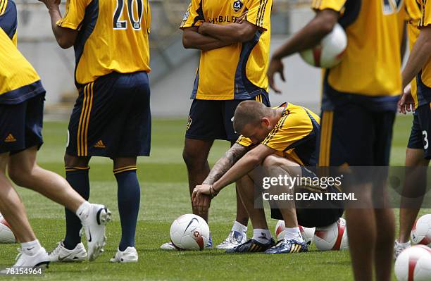 David Beckham of the LA Galaxy sits amongst team mates in front of a crowd of thousands who attended the team's open training session in at Westpac...