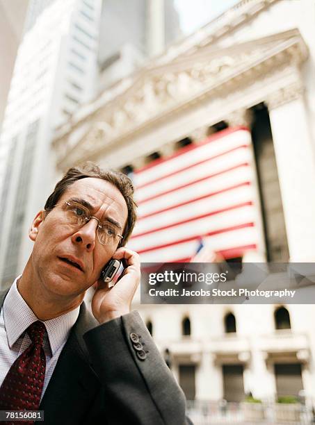 businessman talking on a mobile phone. - unhappy salesman stock pictures, royalty-free photos & images