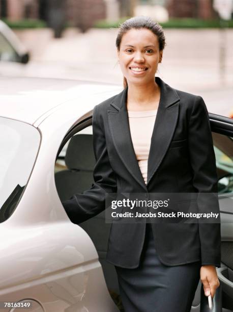 businesswoman getting out of the car - boardmember stock pictures, royalty-free photos & images