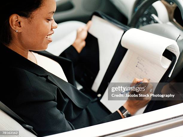 reviewing business notes in the car - boardmember stock pictures, royalty-free photos & images