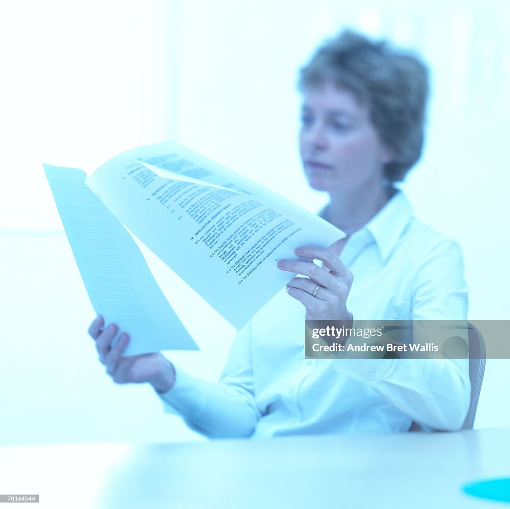 Businesswoman reading papers