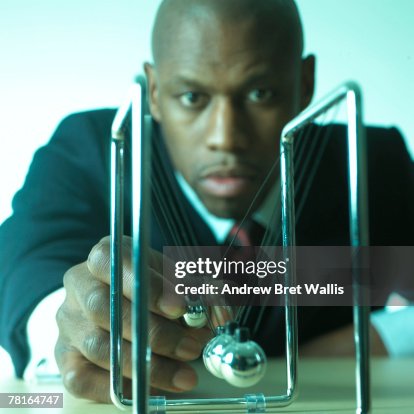 Businessman with a Newton's cradle Businessman with a Newton's cradle