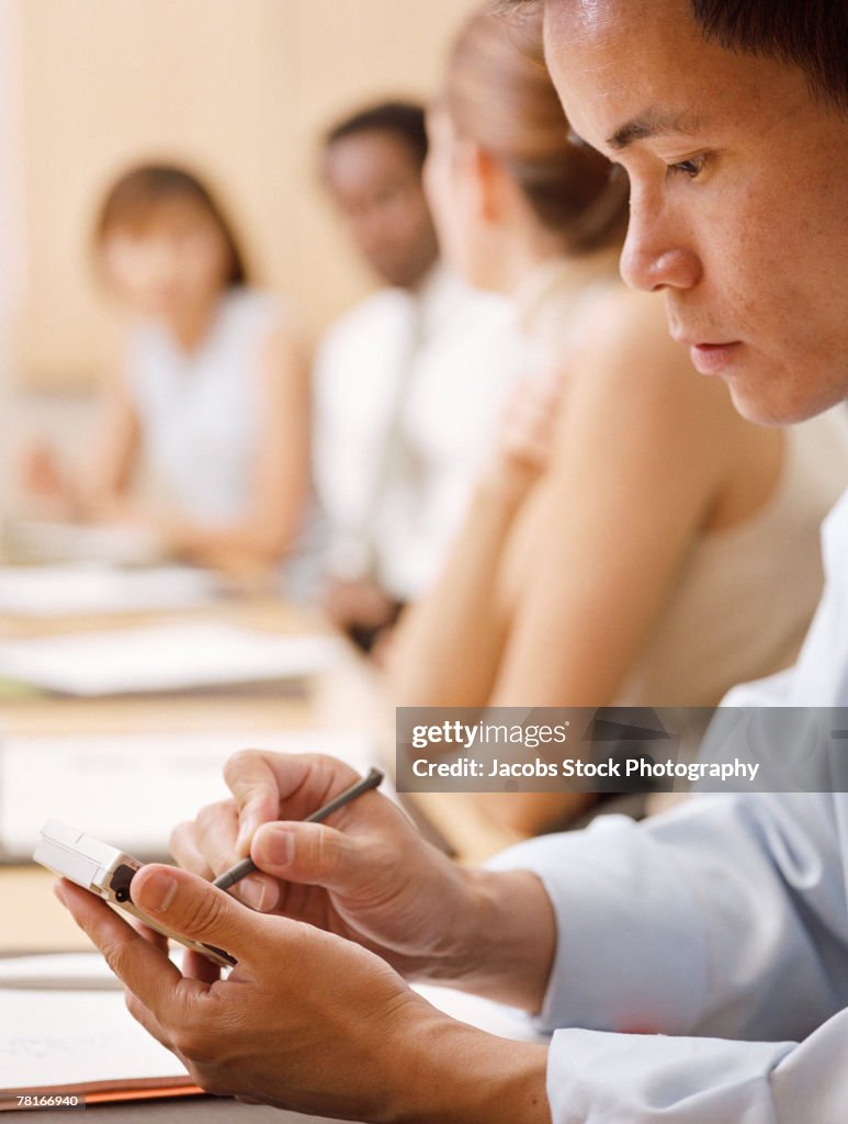 Businessman in meeting with pda
