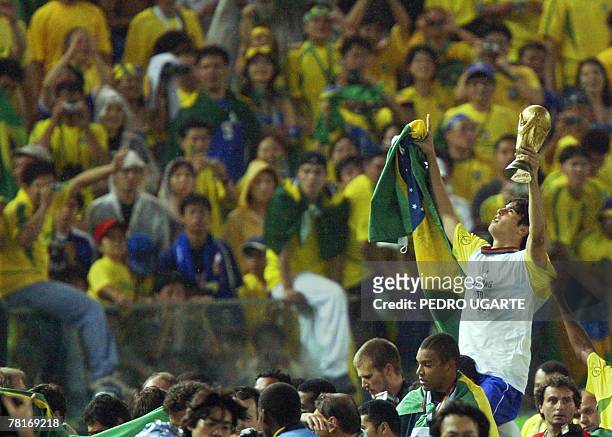- Picture taken 30 June 2002 of Brazilian forward Kaka brandishing the trophy at the end of the Germany/Brazil final of the 2002 FIFA World Cup. Kaka...