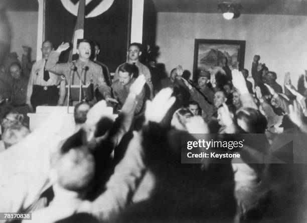 German Nazi leader Adolf Hitler acknowledges the salutes of party members at a party to mark the 14th anniversary of the 1923 Beer Hall Putsch, 9th...