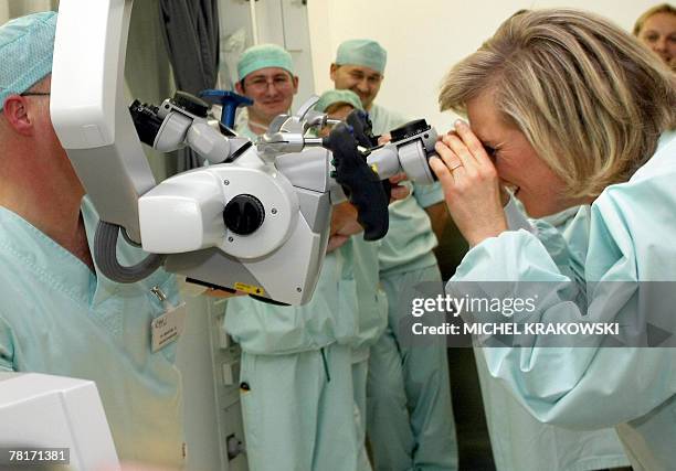 Princess Astrid of Belgium looks into the IRM microscope during a visit at the CHU hospital in Liege, 30 November 2007, on the occasion of the...