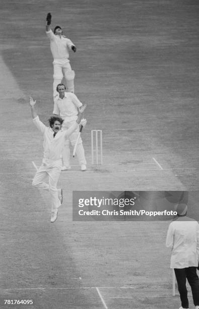 Australian cricketer Dennis Lillee appeals to umpire Dickie Bird for the dismissal of England cricketer Geoff Arnold as wicket keeper Rod Marsh leaps...