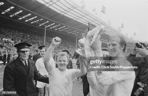 Leeds United players Billy Bremner and Jack Charlton hold the trophy aloft after Leeds United beat Arsenal 1-0 to win the 1972 FA Cup Final at...