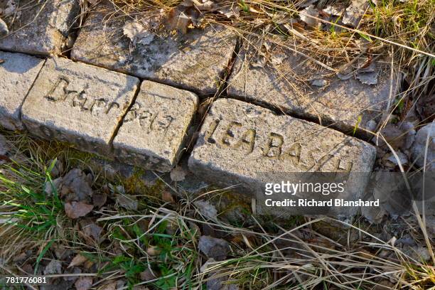 Memorial bricks bearing the names of victims, at the site of the former Bergen-Belsen German Nazi concentration camp in Lower Saxony, Germany, 2014....