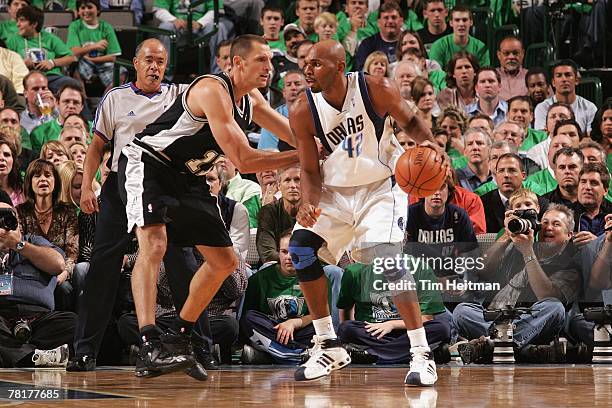 Jerry Stackhouse of the Dallas Mavericks looks to make a move against Brent Barry of the San Antonio Spurs during the game at the American Airlines...