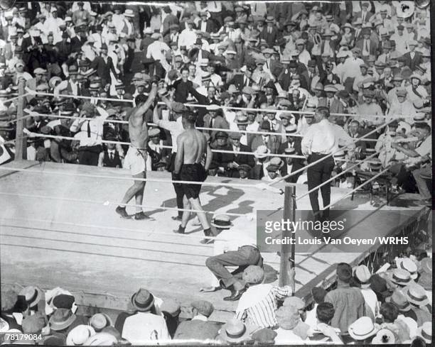 Heavyweight champion Jack Dempsey gets the referee's decision in his title bout with challanger Tommy Gibbons. .