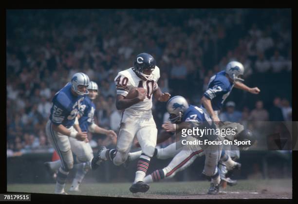 Detroit, MI - CIRCA 1960's: Gale Sayers of the Chicago Bears carries the ball in a mid circa 1960's NFL football game against the Detroit Lions at...