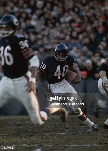 S: Gale Sayers of the Chicago Bears carries the ball in a mid circa 1960's NFL football game at Wrigley Field in Chicago, Illinois. Sayers played for...