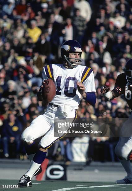 S: Fran Tarkington of the Minnesota Vikings drops back to pass against the Chicago Bears in a mid circa 1970's NFL football game at Soldier Field in...