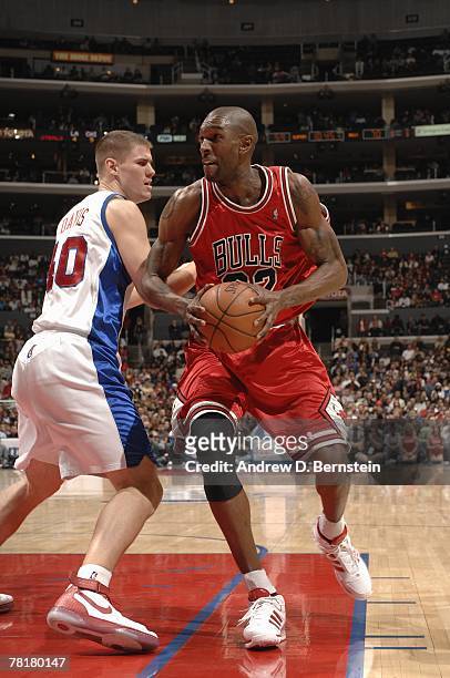 Joe Smith of the Chicago Bulls moves the ball against Paul Davis of the Los Angeles Clippers during the game at Staples Center on November 17, 2007...