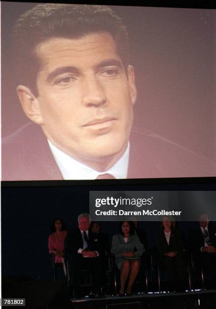 An image of John F. Kennedy JR., is projected over the heads of uncle Ted Kennedy and sister Caroline Kennedy during the John F. Kennedy Profile in...