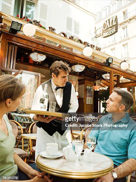 waiter serving a couple - coffee on patio stock pictures, royalty-free photos & images