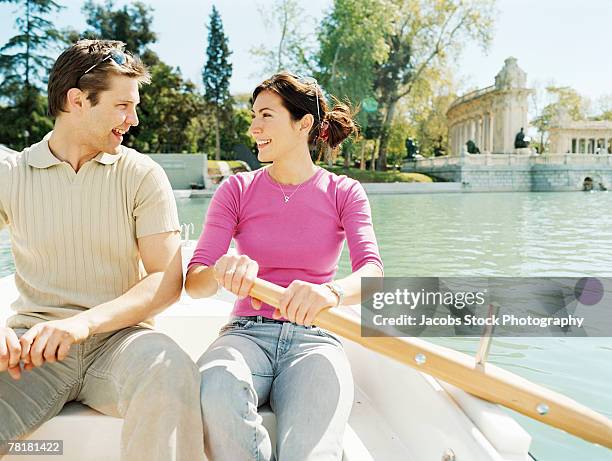 couple on a rowboat - parque del buen retiro stock pictures, royalty-free photos & images