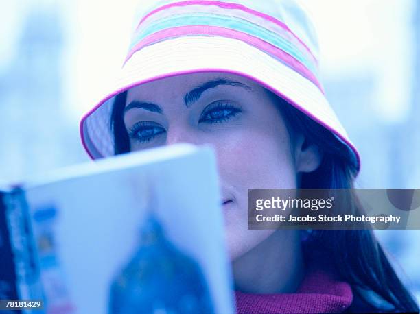 woman reading book - headware stock pictures, royalty-free photos & images