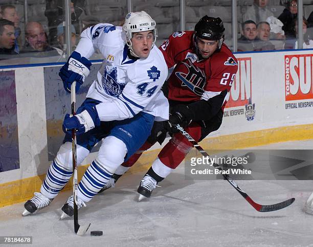 Colin Murphy of the Toronto Marlies battles for the puck with Wes O'Neill of the Lake Erie Monsters November 30, 2007 at the Ricoh Coliseum in...