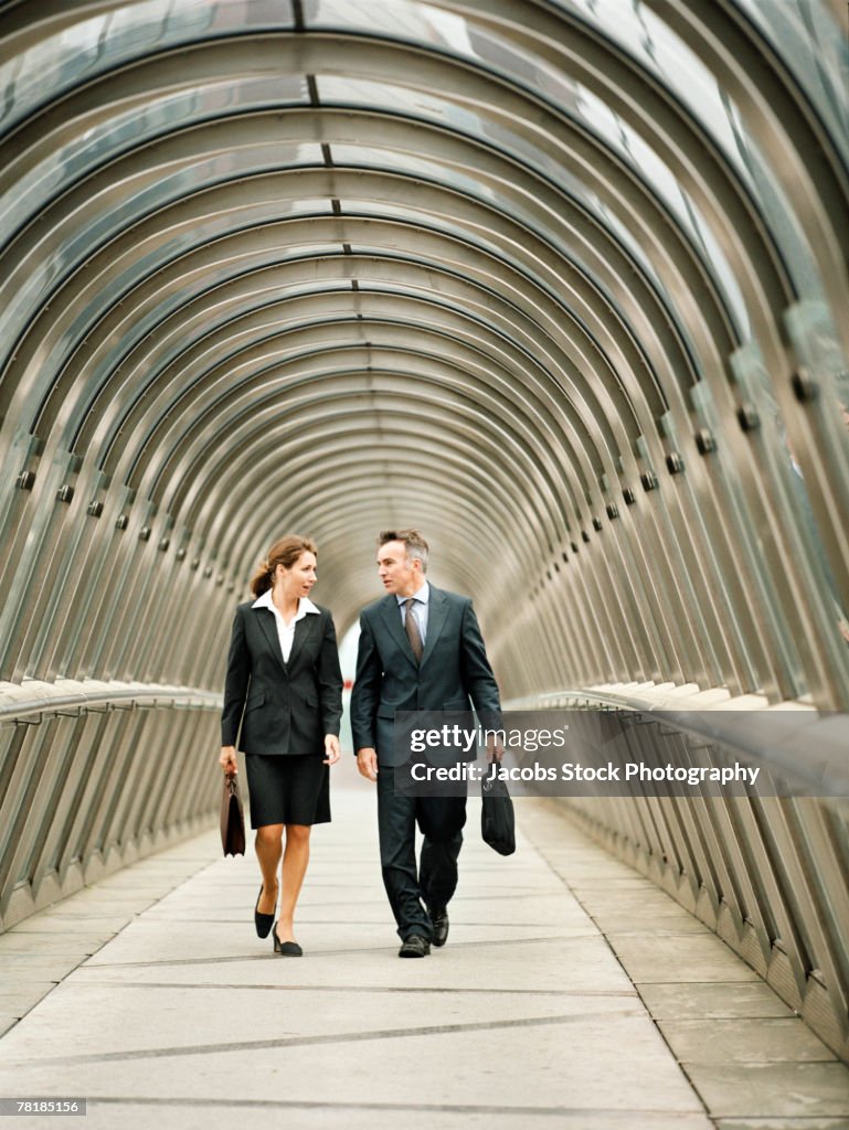 Business colleagues walking in a walkway