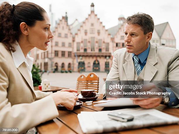 business colleagues meeting at a sidewalk cafe - heat pad stock pictures, royalty-free photos & images
