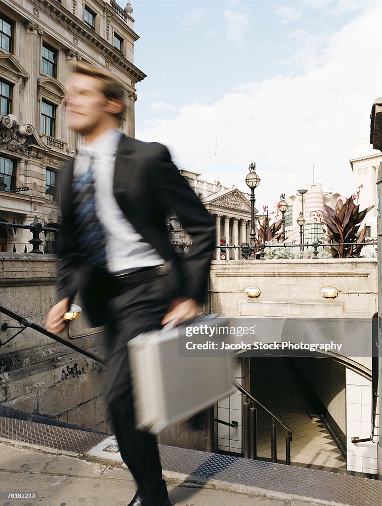 Businessman rushing up stairs