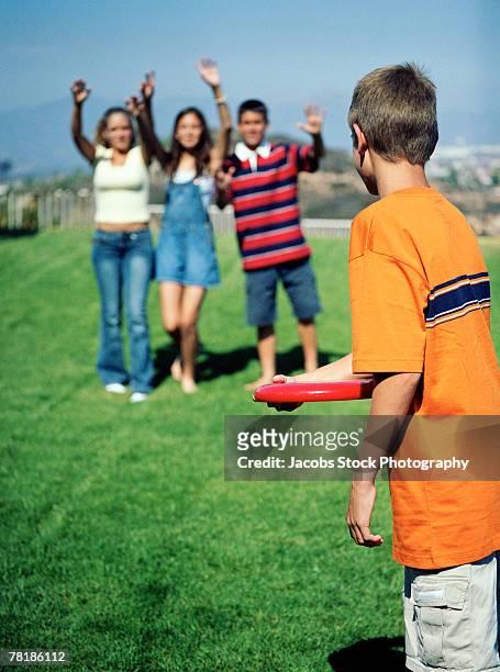 kids playing with throwing disc - pubescent girl stock pictures, royalty-free photos & images