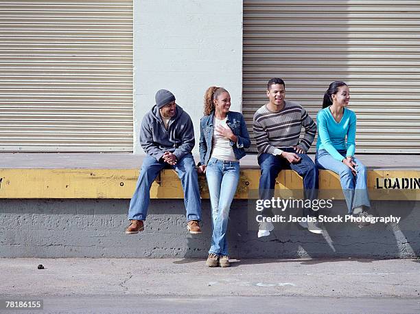 friends sitting on a loading dock - girls open legs fotografías e imágenes de stock