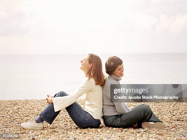 women sitting on shore - girl sitting with legs open stock pictures, royalty-free photos & images