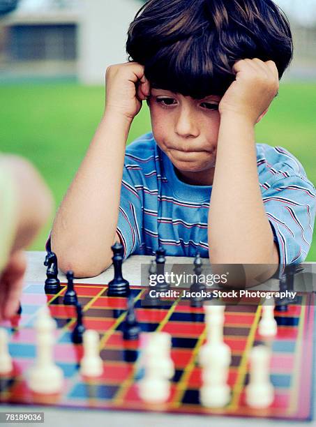 boy playing chess - chess board overhead stock pictures, royalty-free photos & images