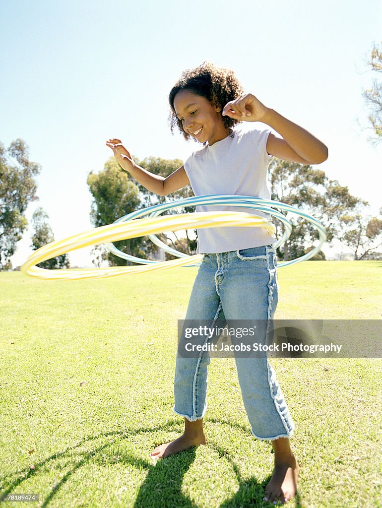 Girl playing with toy hoops