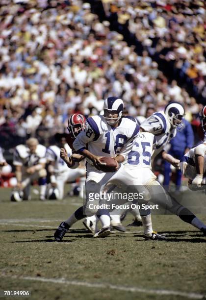 S: Quarterback Roman Gabriel of the Los Angeles Rams turns to hand the ball off against the Atlanta Falcons during a imid circa 1960's NFL football...