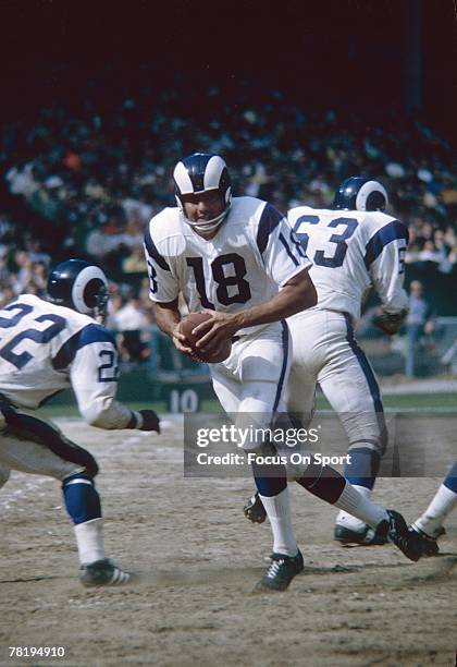 S: Quarterback Roman Gabriel of the Los Angeles Rams drops back to pass against the New York Giants during a mid circa 1960's NFL football game at...