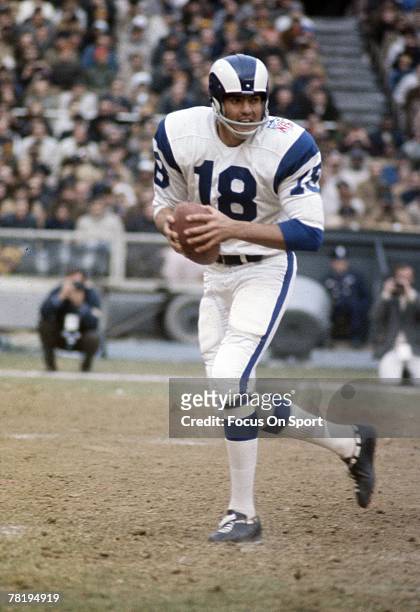 S: Quarterback Roman Gabriel of the Los Angeles Rams drops back to pass against the New York Giants during a mid circa 1960's NFL football game at...