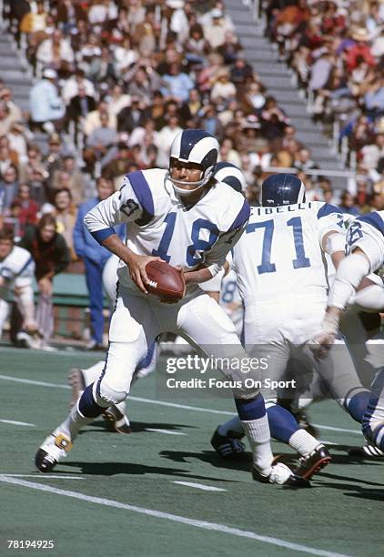 S: Quarterback Roman Gabriel of the Los Angeles Rams turns to hand the ball off against the Philadelphia Eagles during a early circa 1970's NFL...