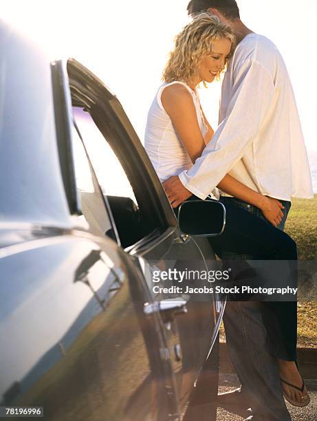 couple embracing on car - couples making passionate love fotografías e imágenes de stock