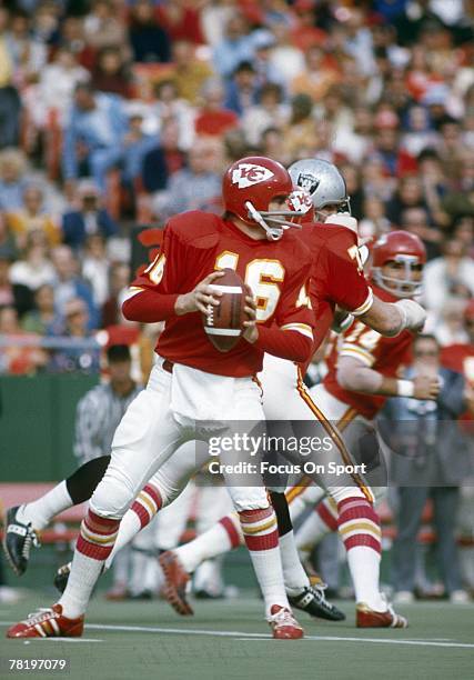 S: Quarterback Len Dawson of the Kansas City Chiefs drops back to pass against the Oakland Raiders during an early circa 1970's NFL football game at...