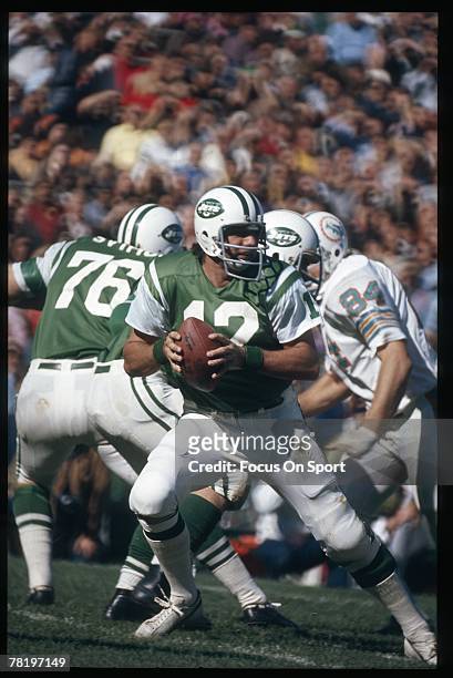 S: Quarterback Joe Namath of the New York Jets, drops back to pass against the Miami Dolphins during an early circa 1970's NFL football game at Shea...